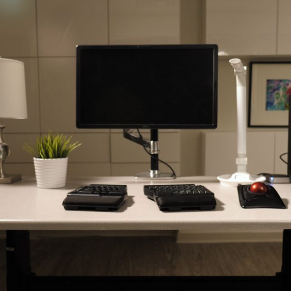 Desk with computer and assistive technology equipment