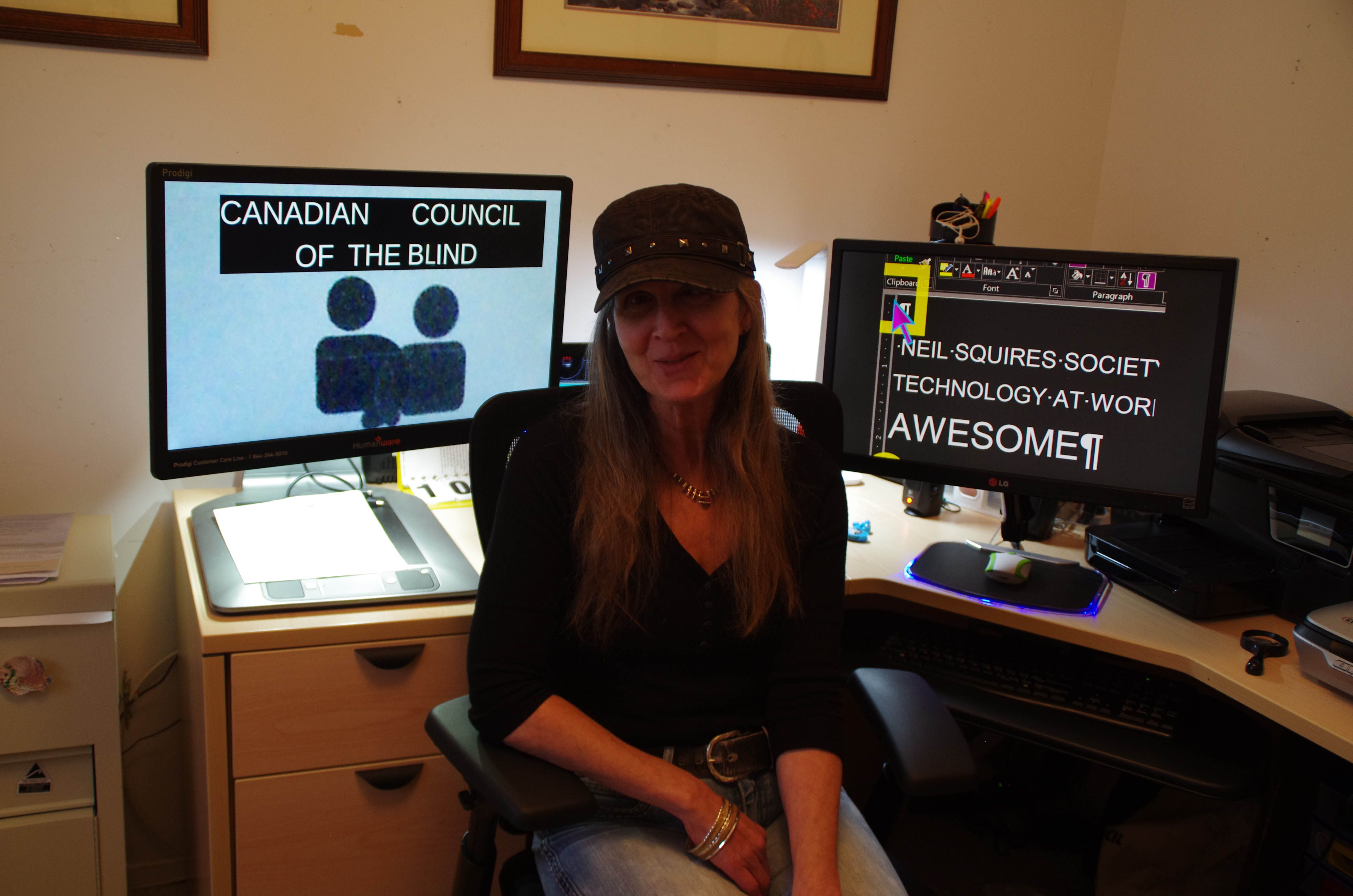 Girl sitting in front of two computers