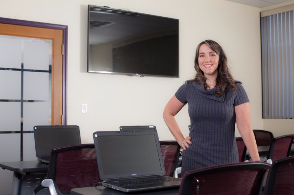 Girl standing in a room with computers