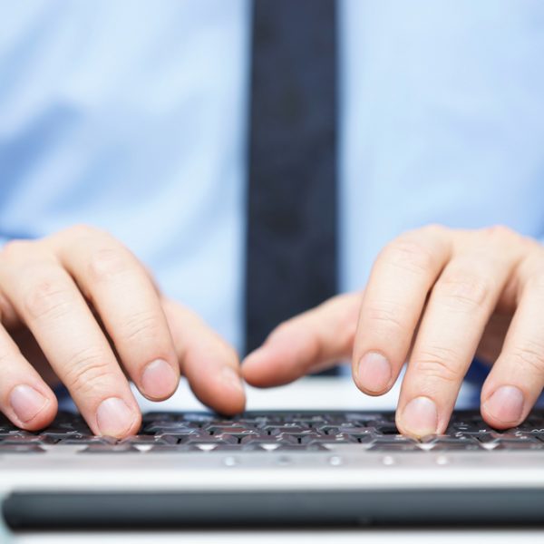 Hands typing on a keyboard