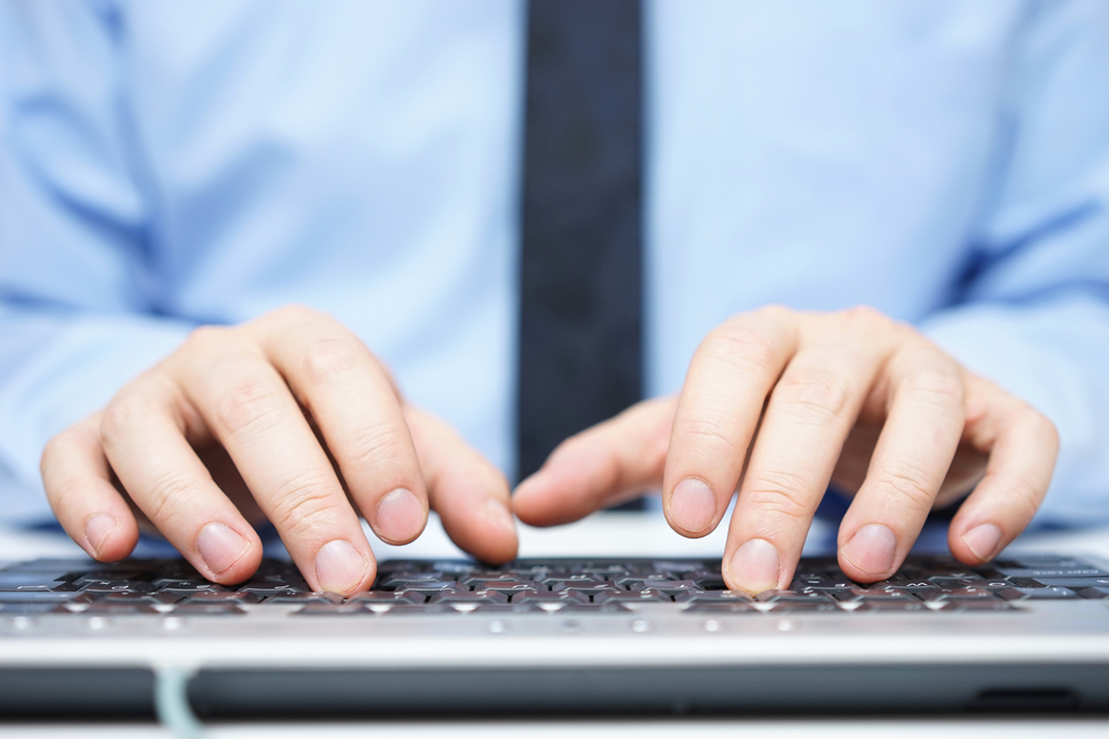 Hands typing on a keyboard