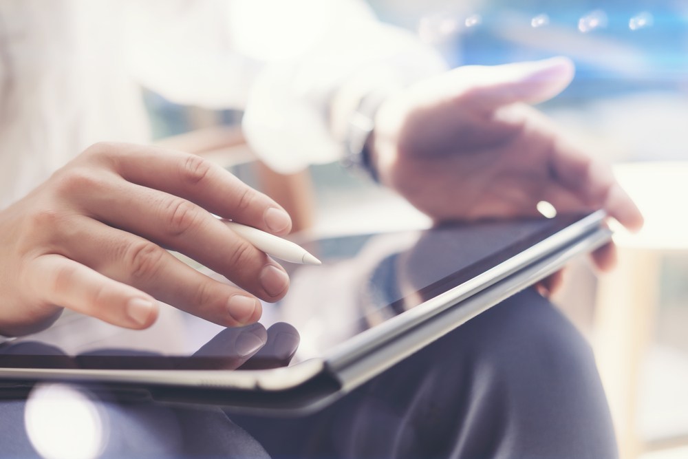 Person using tablet with stylus