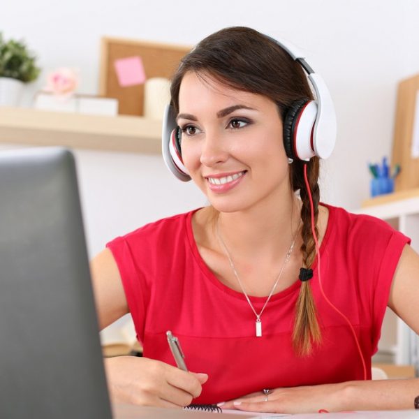 Woman with headphones at computer