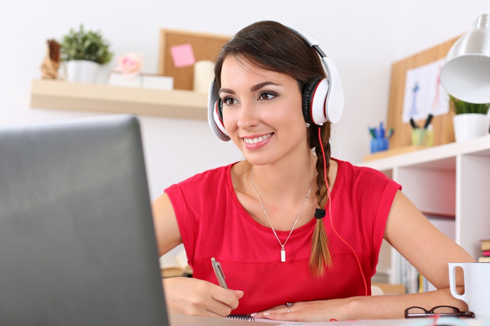 Woman with headphones at computer