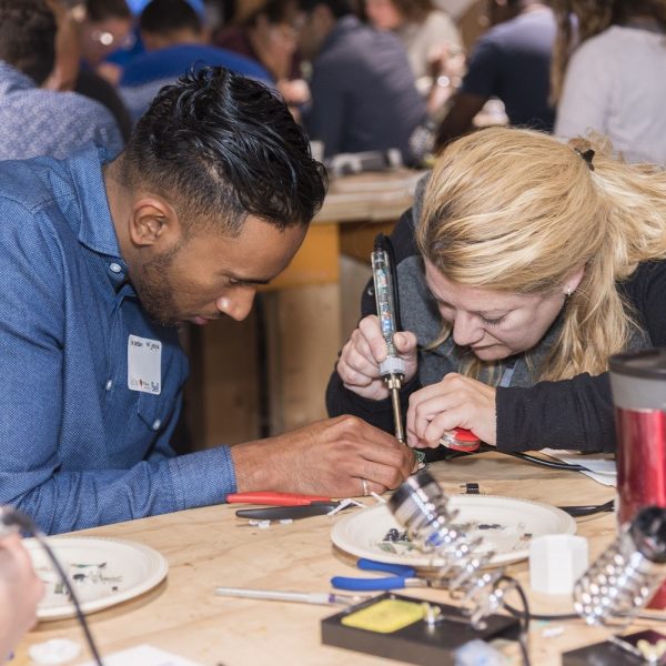 Makers soldering at a previous buildathon