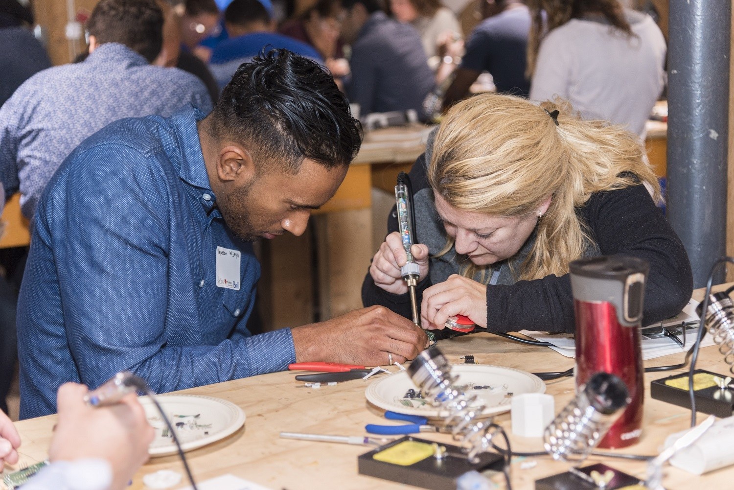 Makers soldering at a previous buildathon