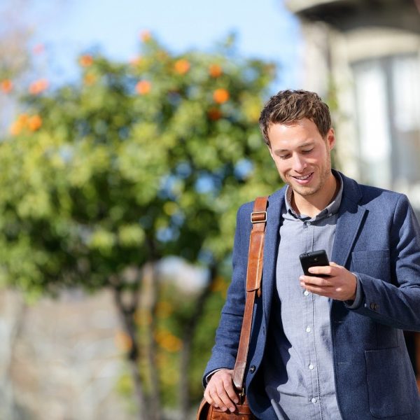 Man walking on the street looking at his phone