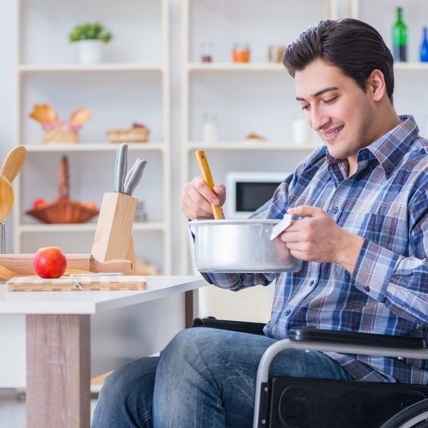 a man in a wheelchair making food