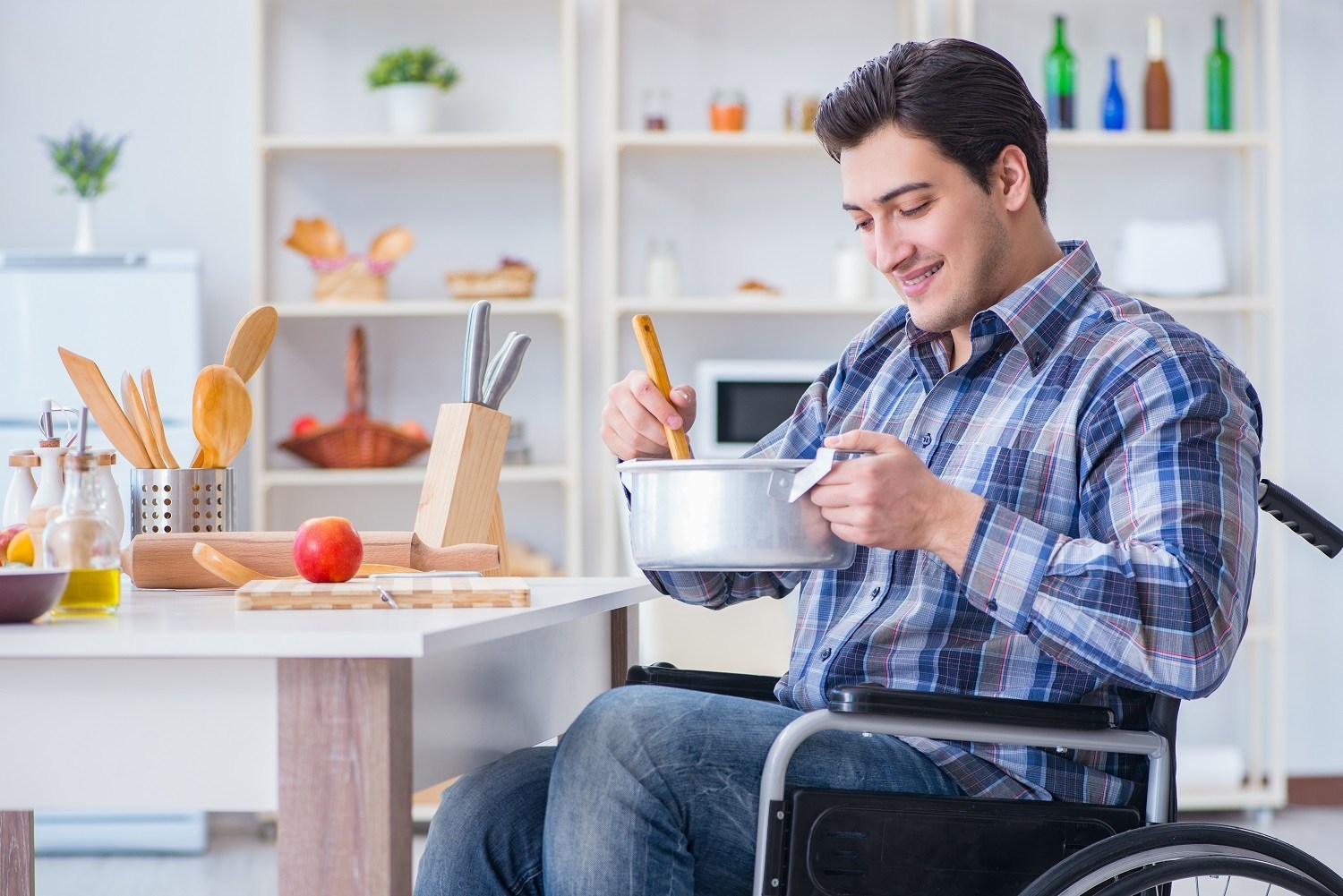 a man in a wheelchair making food