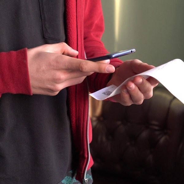 man scanning a receipt with a smartphone