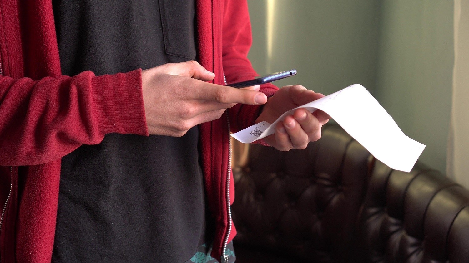 man scanning a receipt with a smartphone