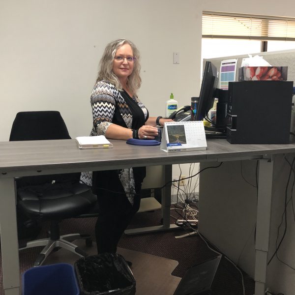 Gail at her sit-stand desk