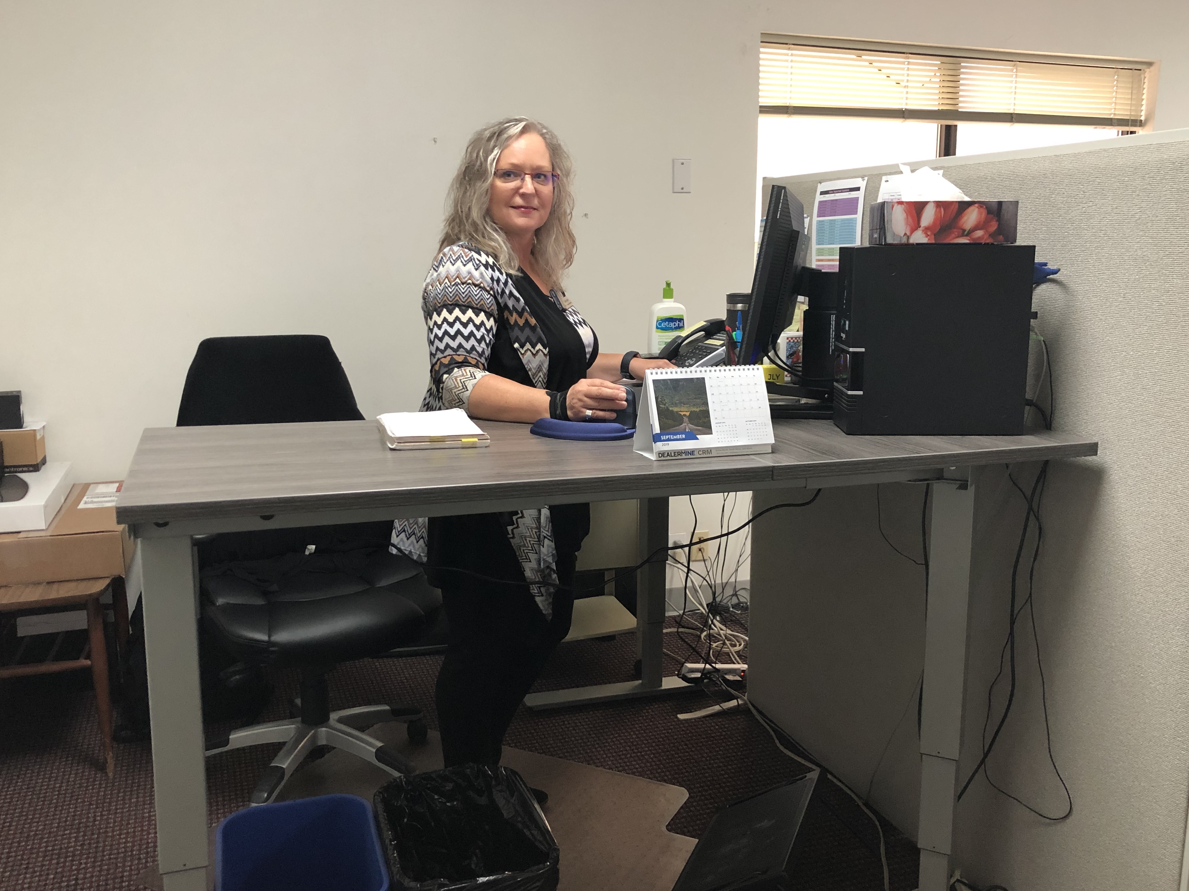 Gail at her sit-stand desk