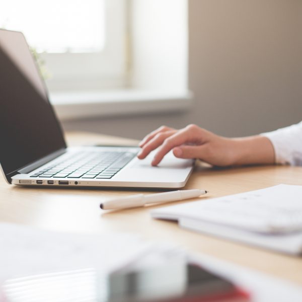 A woman at a desk using a laptop