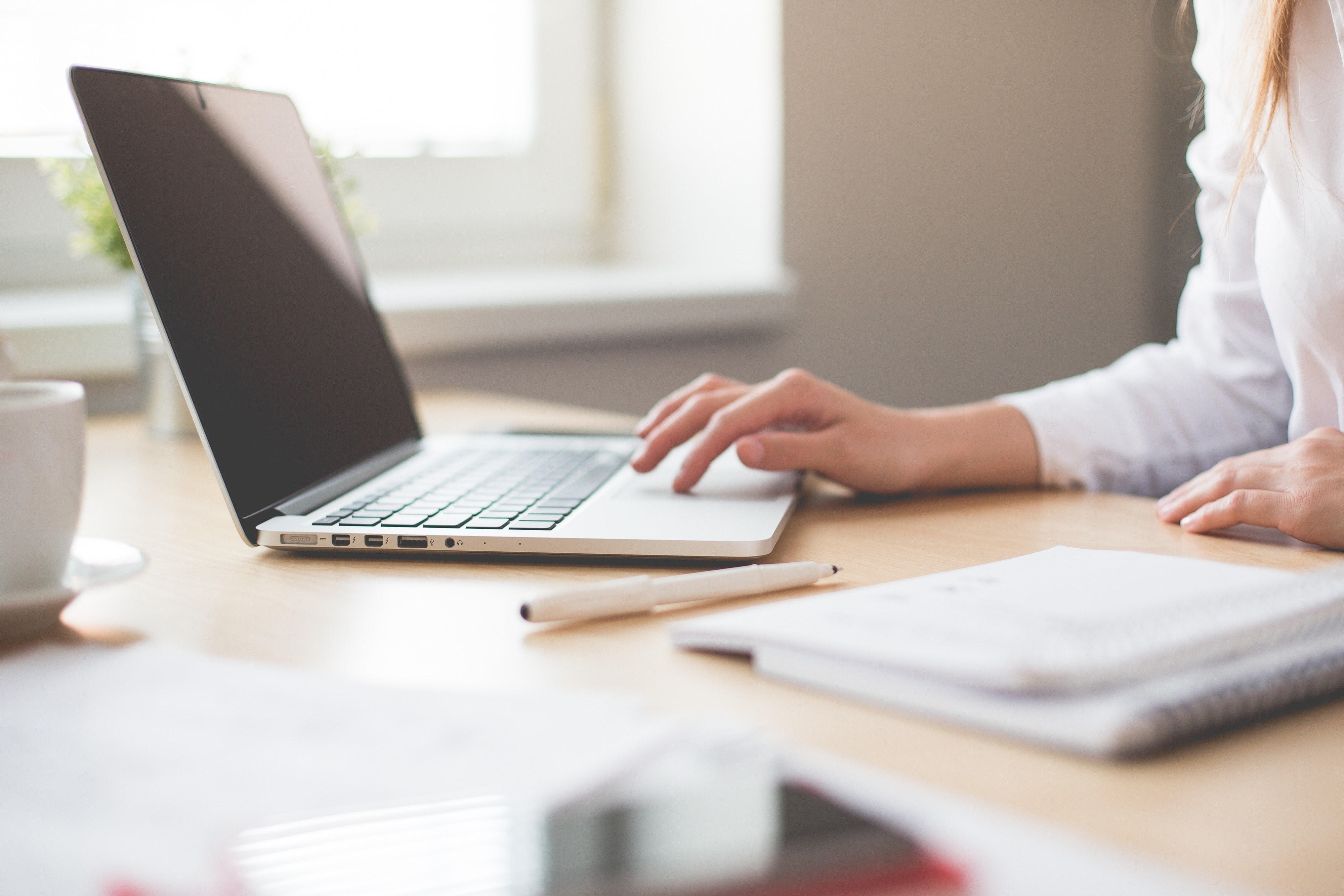 A woman at a desk using a laptop