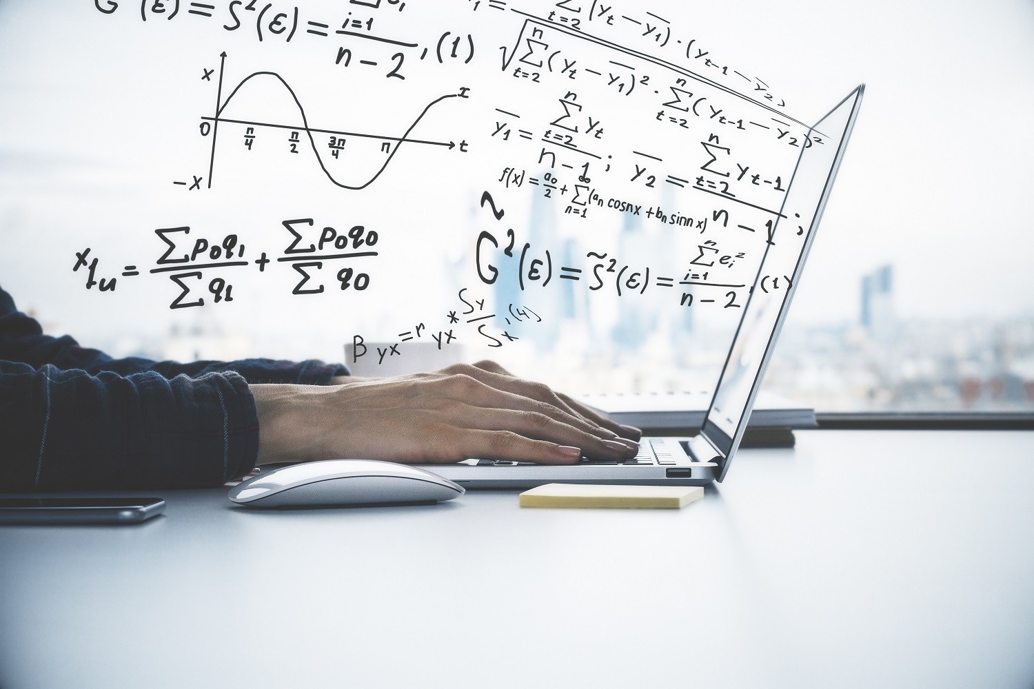 stock image of hands on a laptop with equations coming out of the screen