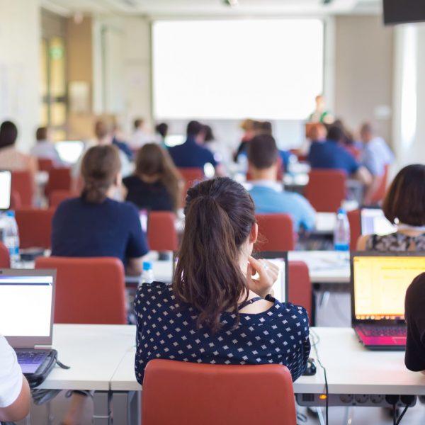 a classroom setting with students listening to a presentation