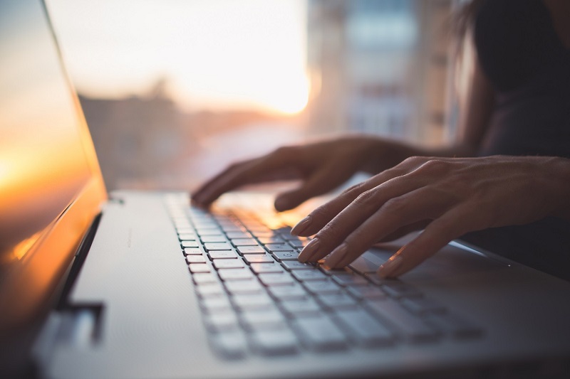 hands on a laptop keyboard