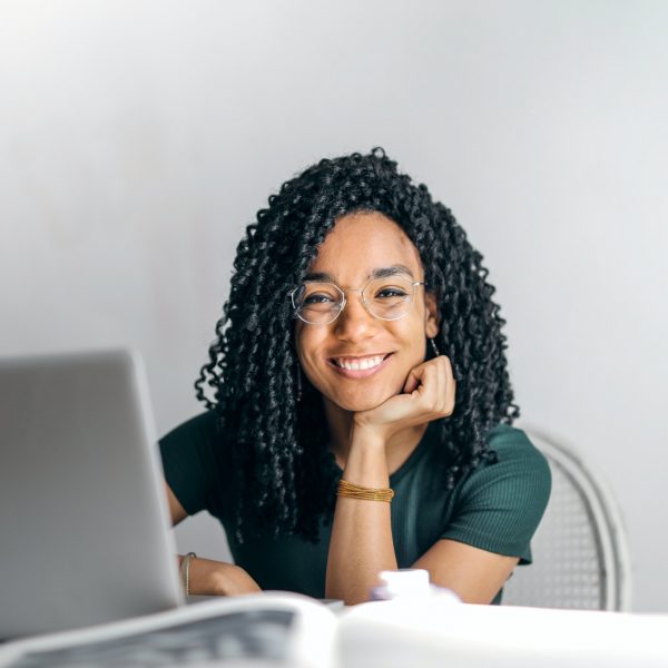 woman working at her laptop, smiling