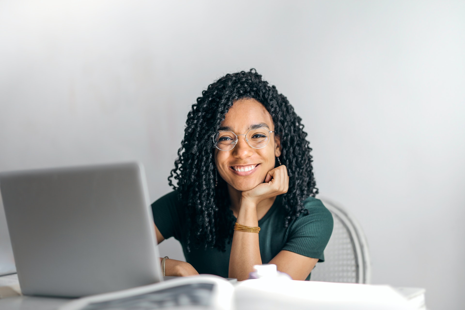 woman working at her laptop, smiling