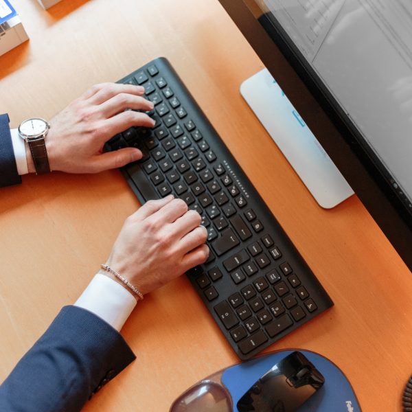 top view of person typing at computer