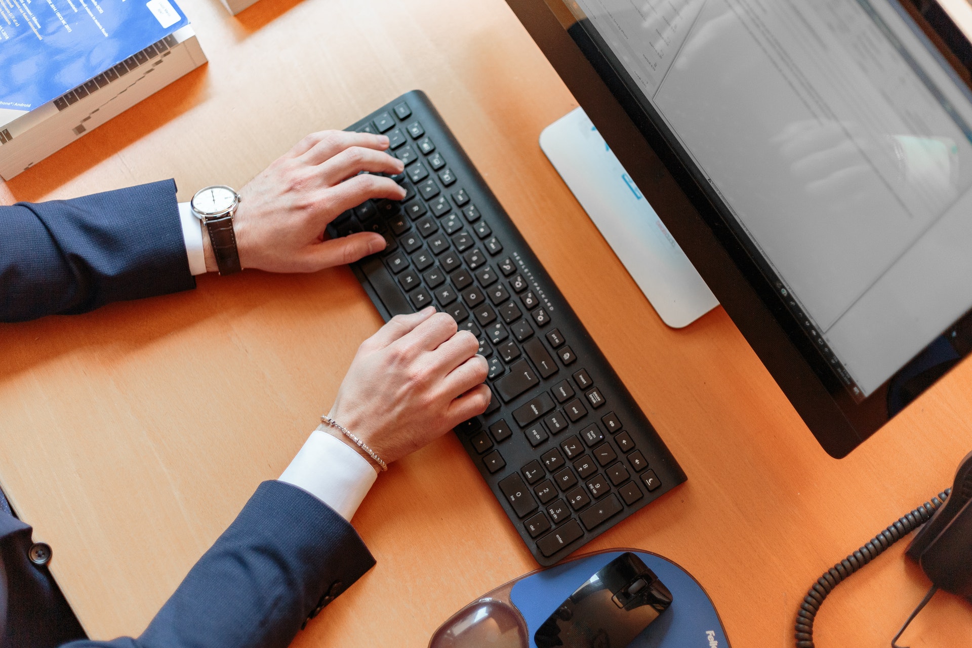 top view of person typing at computer