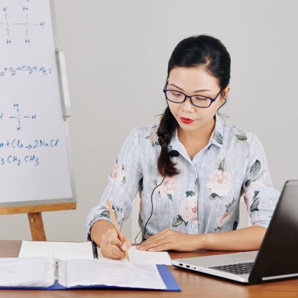 a woman writing in a notebook