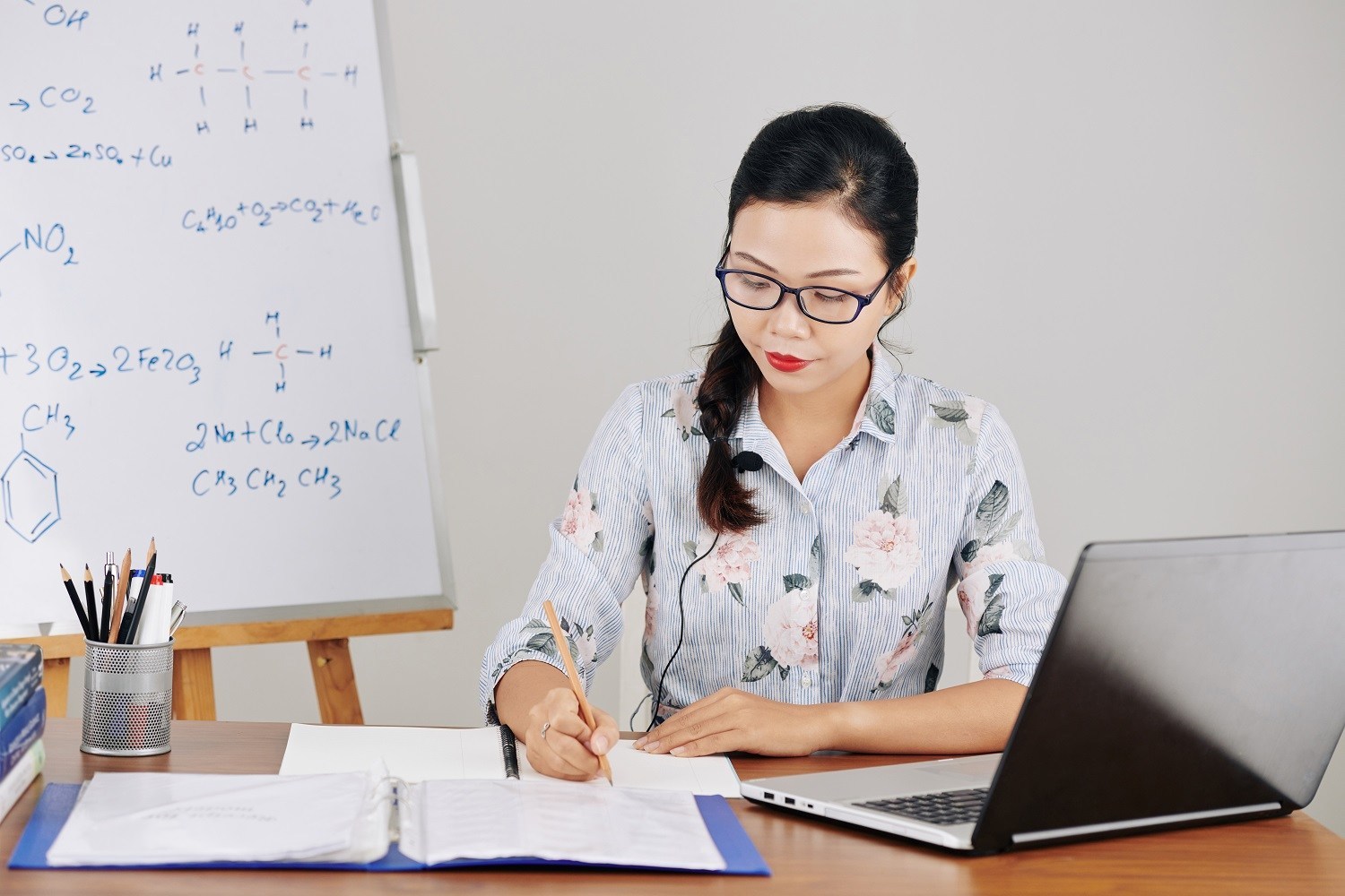 a woman writing in a notebook