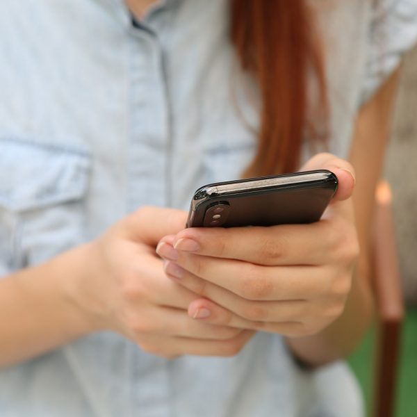 Close-up of person's hands using a smartphone