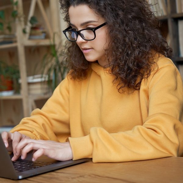 a student typing on a laptop