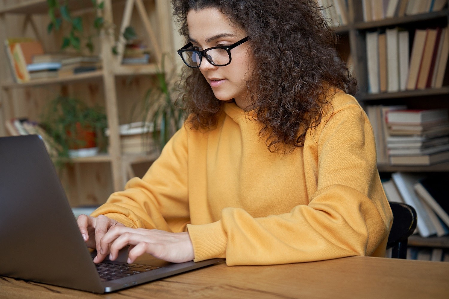 a student typing on a laptop