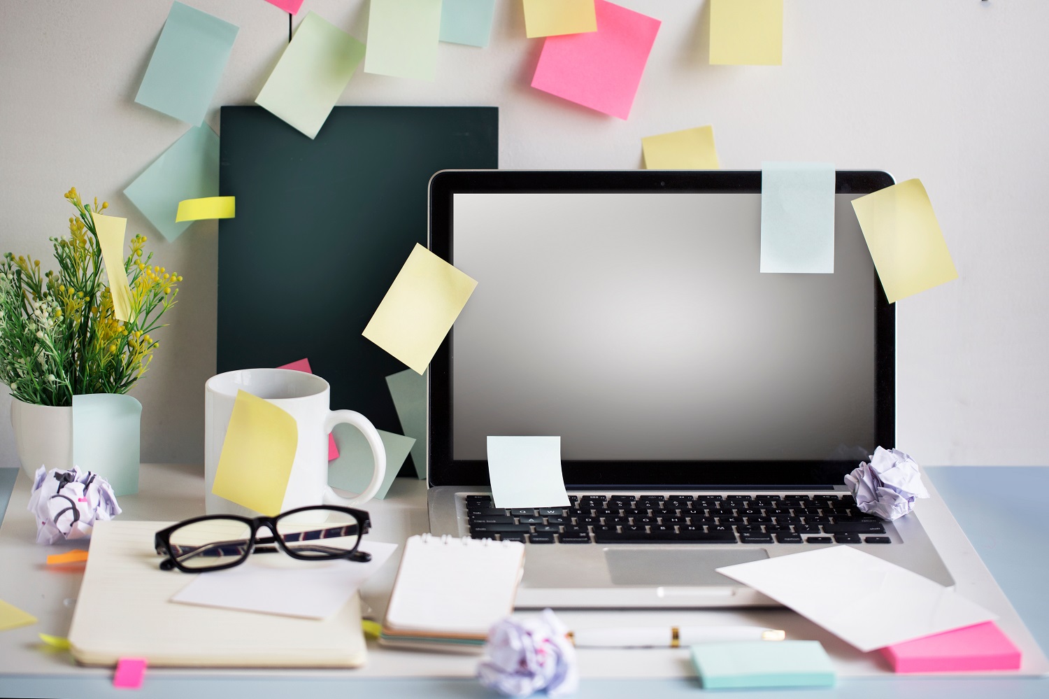 A laptop with a number of post-its all over it