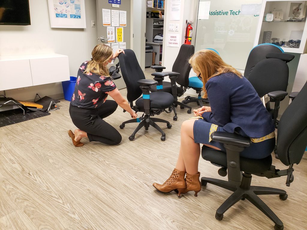 Solutions staff demonstrate ergonomic chairs