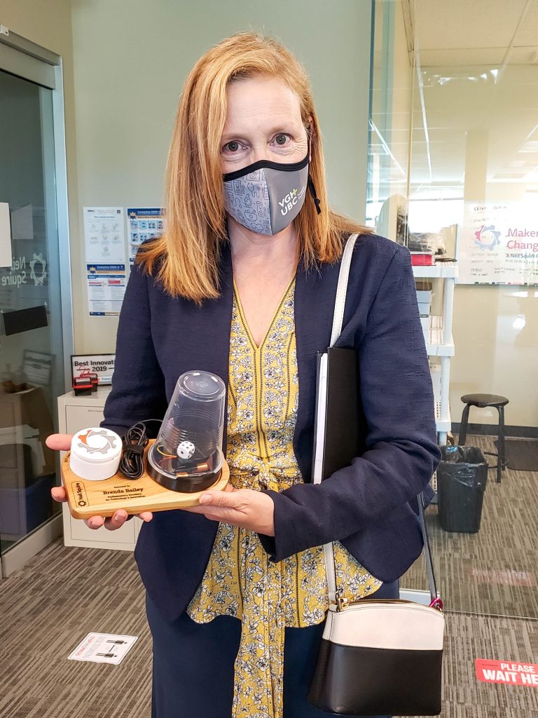 Brenda Bailey showing off a dice spinner and other pieces she received from Makers Making Change