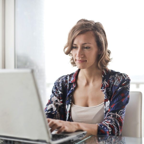 a woman typing on a laptop