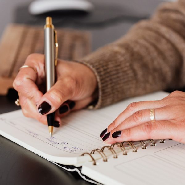 a person writing in a notebook