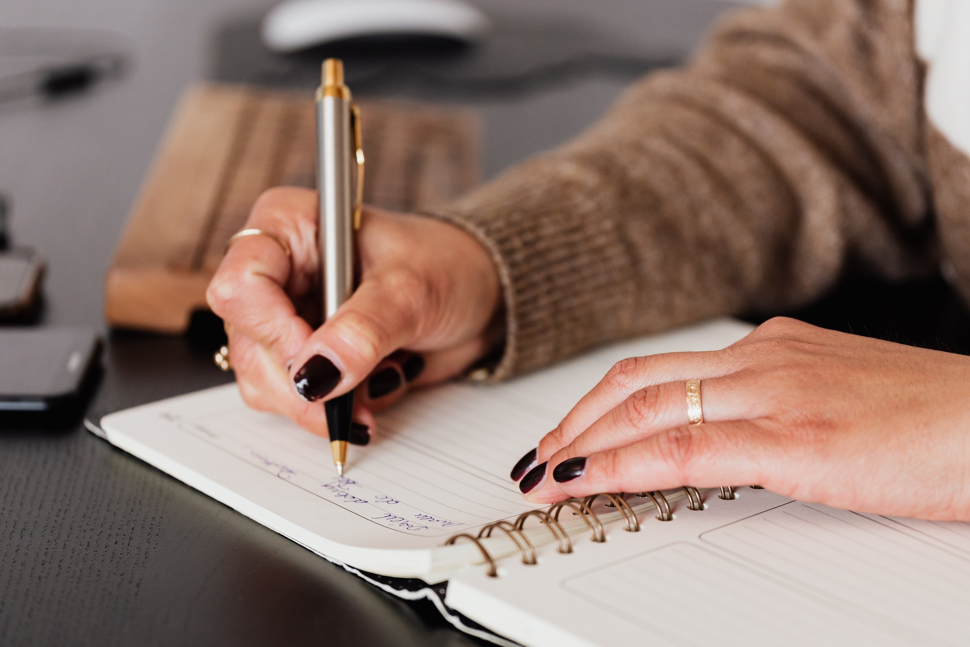 a person writing in a notebook