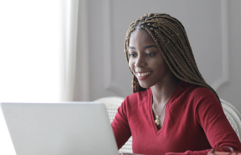 a woman browses her laptop