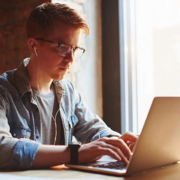 a young student browses their laptop