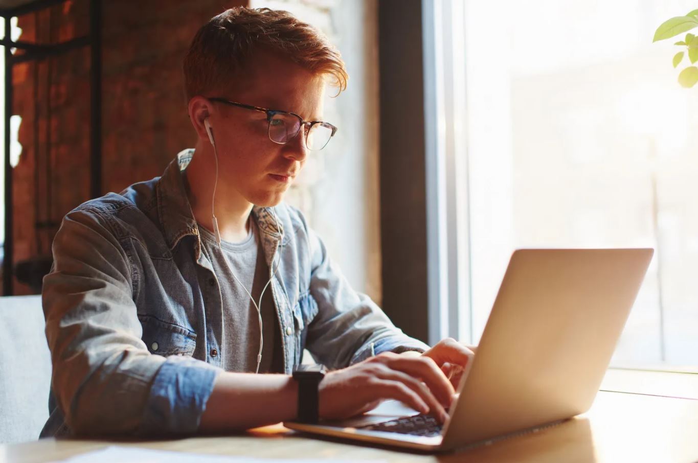 a young student browses their laptop