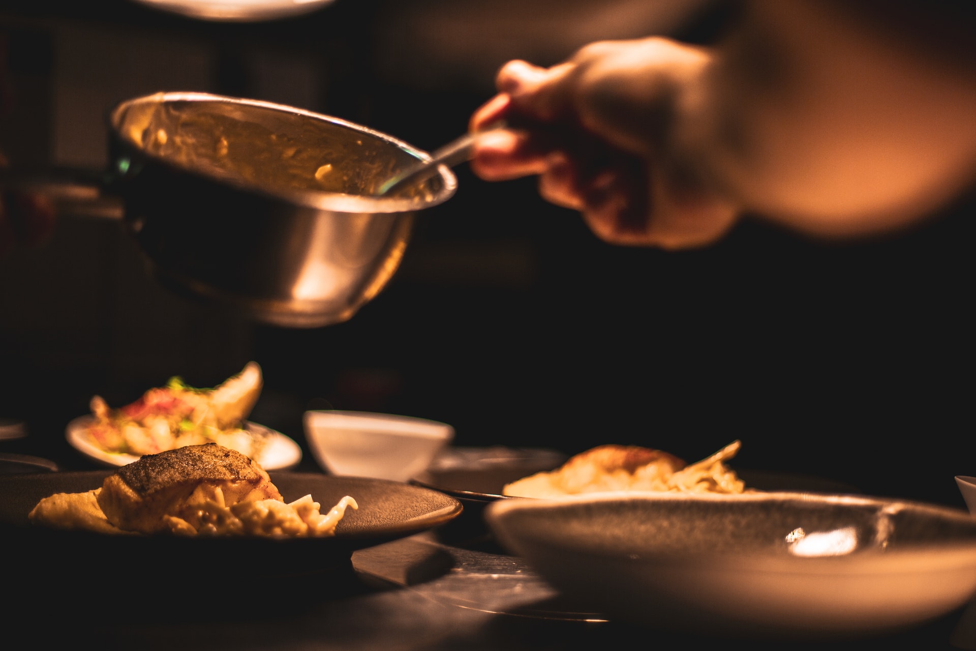 A person cooking food in a pan