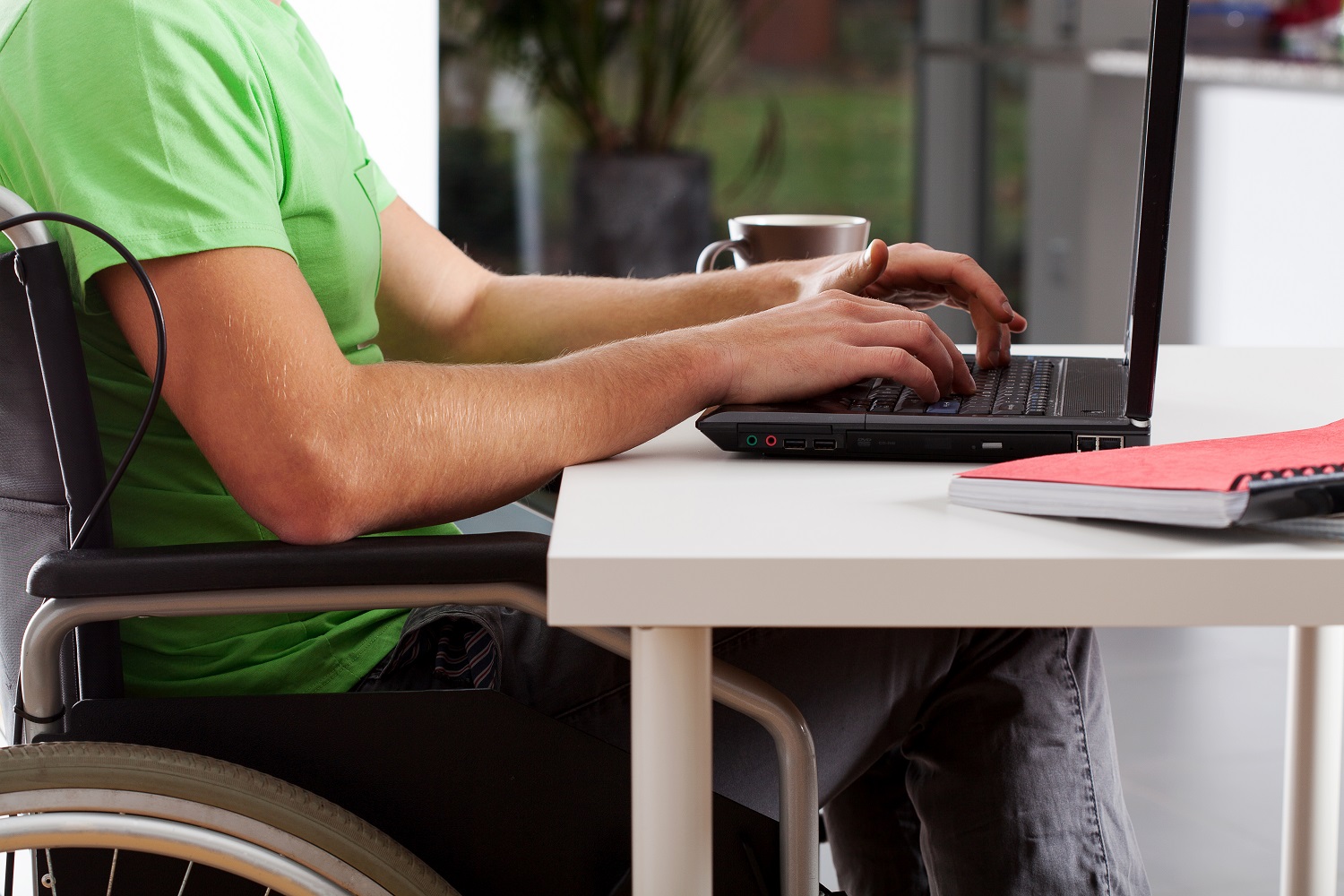 a person in a wheelchair using a laptop