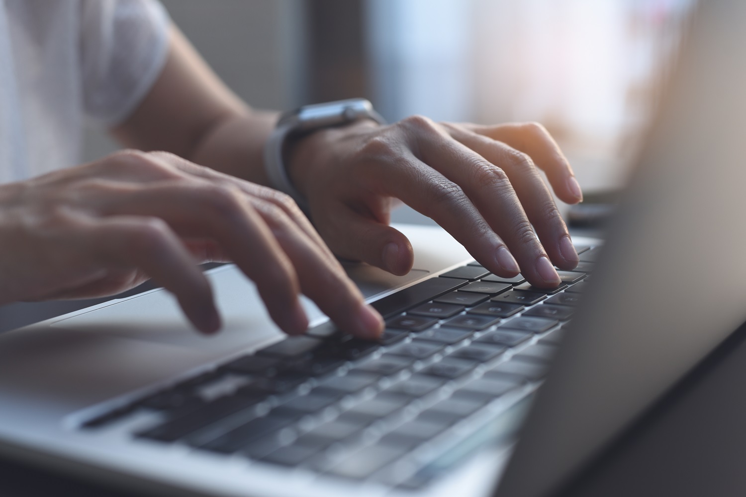 a person typing on a laptop