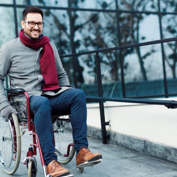 a man in a wheelchair on a sidewalk