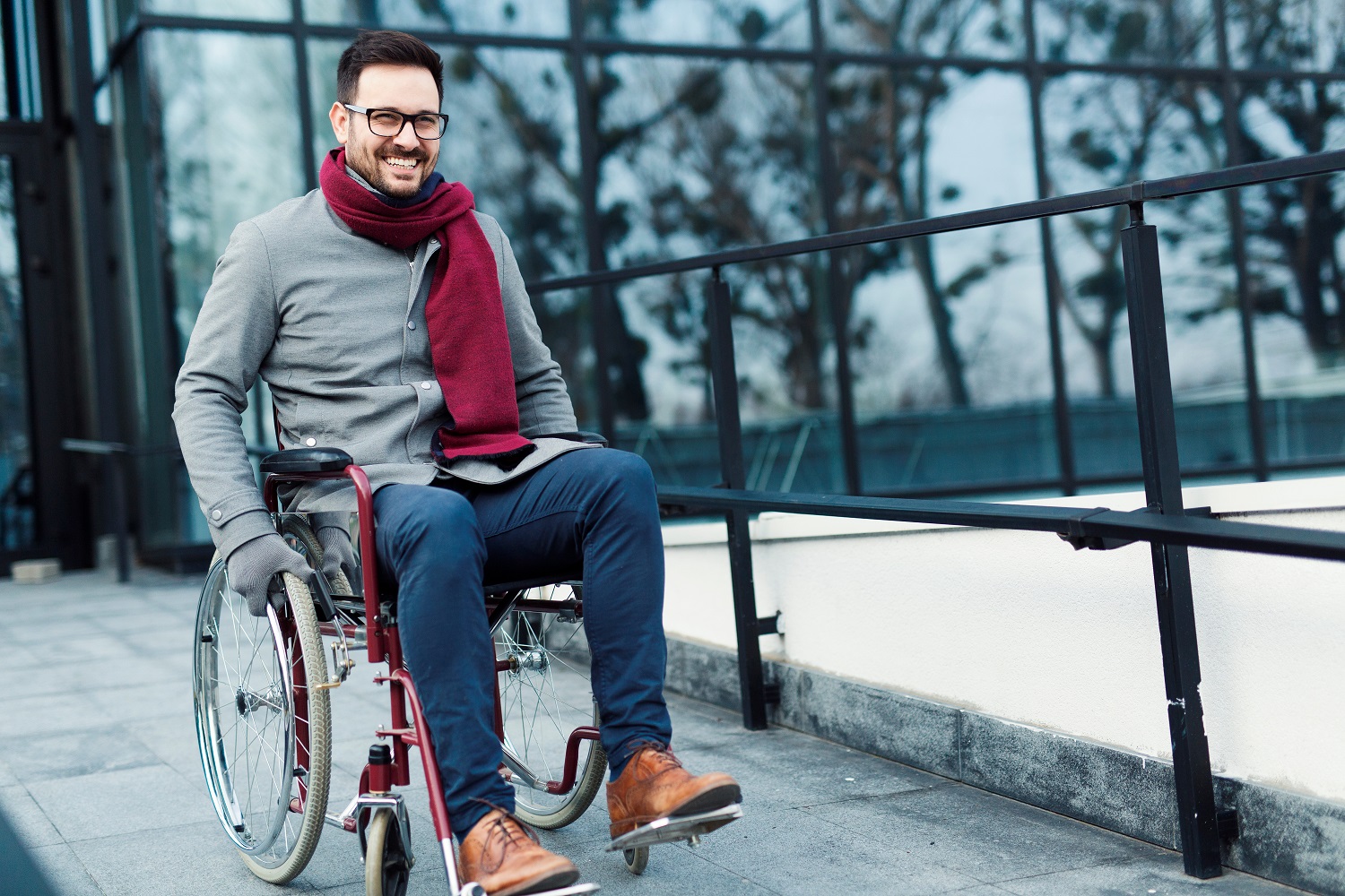 a man in a wheelchair on a sidewalk