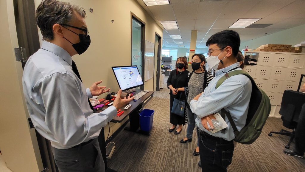 Chad demonstrating the different assistive technology in the Makers Making Change lab