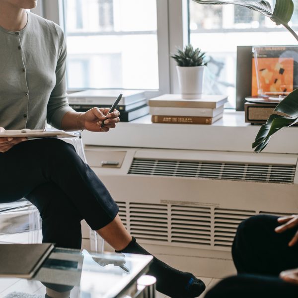 woman with clipboard talking with a client