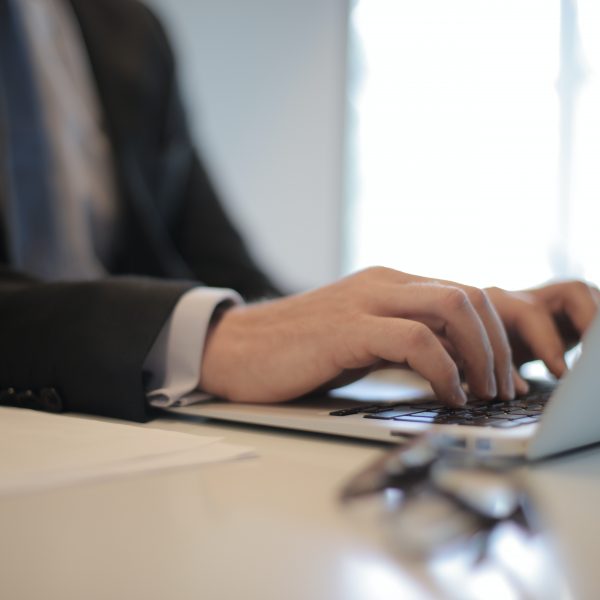 a man in a suit using a laptop