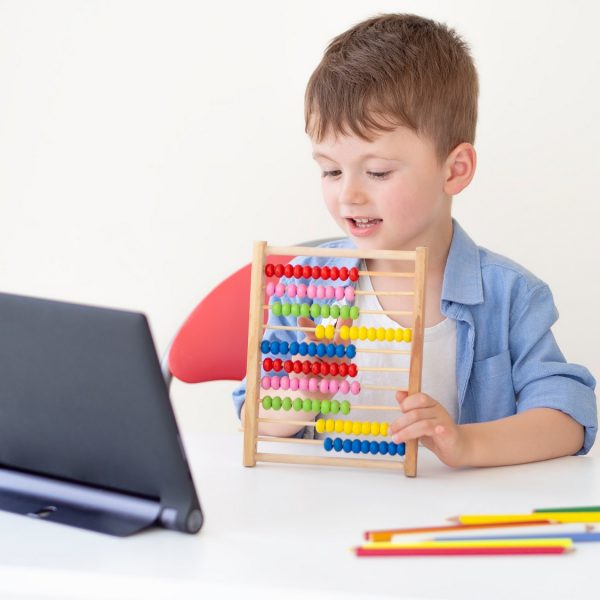 a child playing with an abacus in front of a tablet