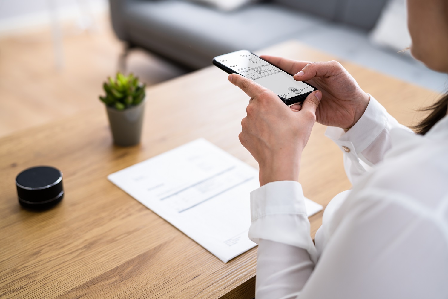 a person using an app on their phone to scan a document